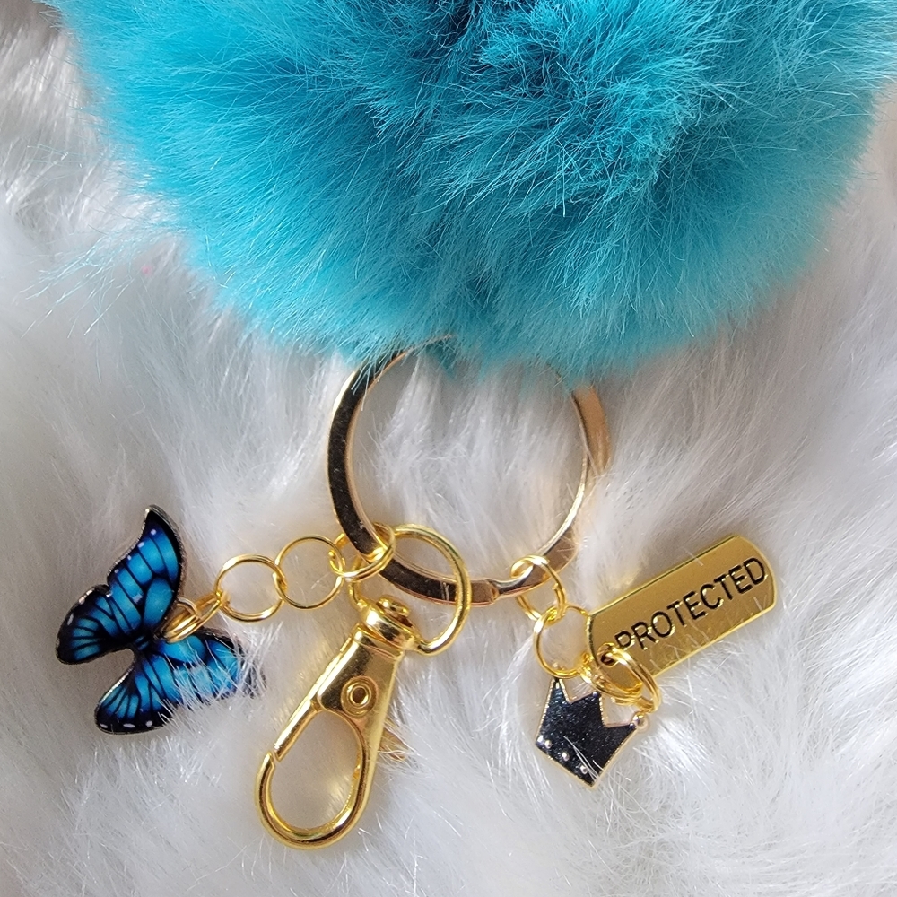 Pom Pom keychain with 🦋 charm and crown